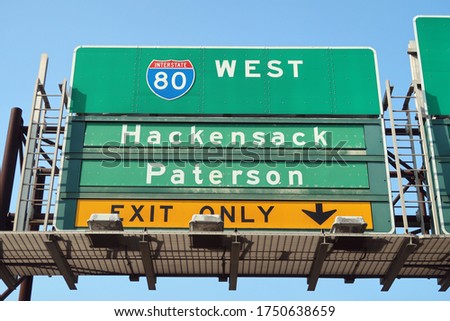 Highway sign for Route 80 West to Hackensack and Paterson. Exit only.                                