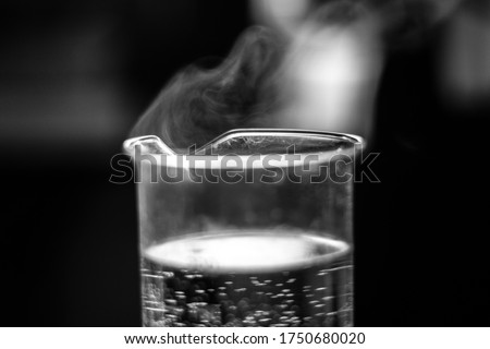 Water evaporation experiment on glass beaker black and white Royalty-Free Stock Photo #1750680020