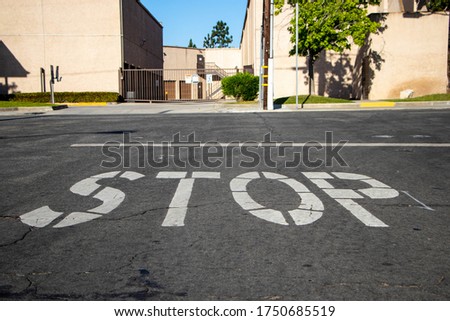White stop sign on pavement