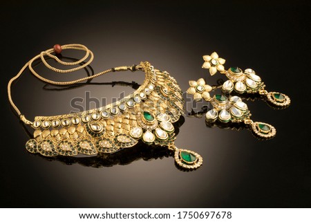 Indian traditional jewellery neckless and earings over black background, Selective focus
 Royalty-Free Stock Photo #1750697678