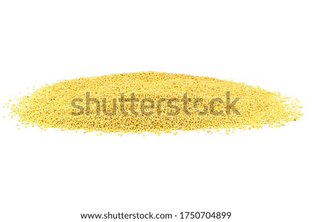 A large pile of millet groats on a white background. Studio shot.