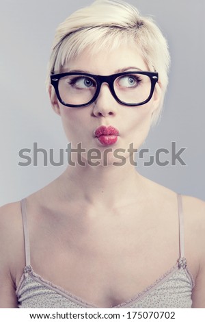 Nerdy and thinking girl with horned glasses. Naturally toned.