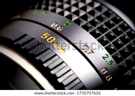 Vintage manual focus lens in blur. Standard lens. Vintage analog photographic equipment with shallow depth of field.