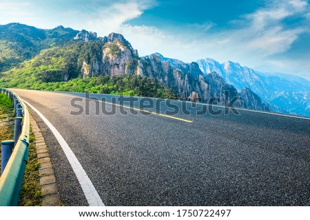 Empty asphalt road and mountain natural scenery on a sunny day.
