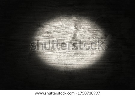 a dark empty room with light leading to a wall