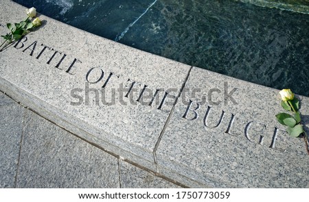 Inscription Battle of the Bulge and two roses on the World War II Memorial, Washington, D.C. Royalty-Free Stock Photo #1750773059