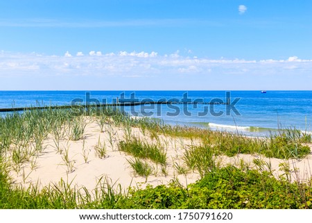 Beautiful white sand beach and blue sea in Darlowko village, Baltic Sea coast, Poland