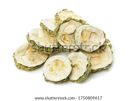 Dried bitter gourd slices on a white background