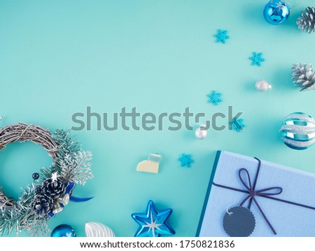 Gifts and christmas decorations on light blue background. Space for text.