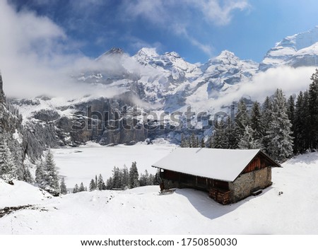 Panoramic winter landscape with frozen lake oeschinen and snow covered mountains, switzerland kandersteg. Royalty-Free Stock Photo #1750850030