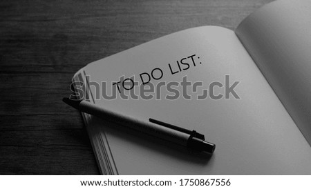 B/W To do list writing on notebook - Business concept.