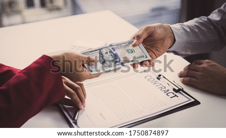 Businessmen give dollars to bribe employees in signing contracts to buy illegal land and real estate, Business fraud and social injustice, corruption and bribery concept.