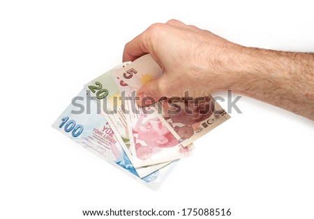A hand holding a mixture of Turkish Lira Currency, on a white background.