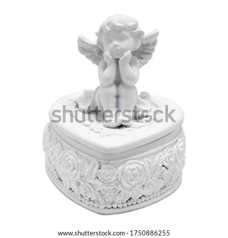 Isolated close up view of decorative souvenir white porcelain jewelry box with an angel on white background.