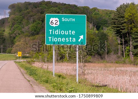 A Pennsylvania Department of Transportation road sign along State Route 6 for the exit for State Route 62 to Tidoute and Tionesta in Warren County, Pennsylvania, USA