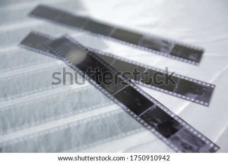Film photography special  archival envelope slips for negative storage. 35mm and medium format photography. Film strips laying down on a table.