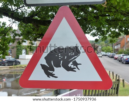 Beware of frogs or toads crossing road sign