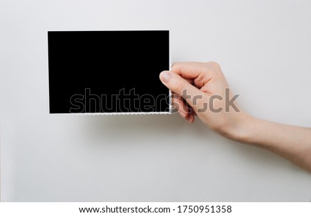 a photo frame in the hands of a girl