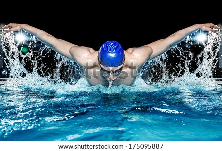 Muscular young man in blue cap in swimming pool Royalty-Free Stock Photo #175095887