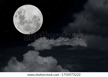 Full moon with blurred clouds in the dark night.