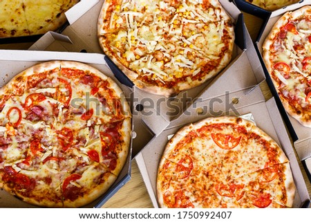 Delicious juicy meat cheese pizza on the table in a box