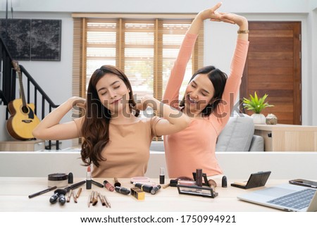 Young Asian beautiful woman couple stretch lazily while working, online selling at home. Concept of beauty blogger working, online selling, or shopping at home for stock photo. 
