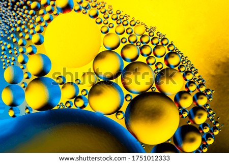 Macro shot of oil bubbles with water on colorful background. Space and universe planets styled psychedelic abstract image.