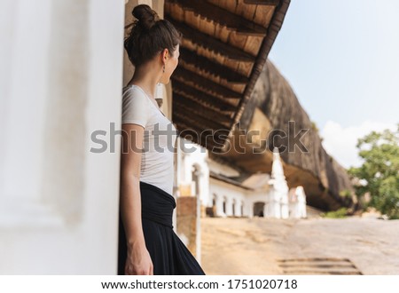 Woman is looking out from Dambulla Cave Temples