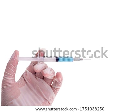 Hands wearing white rubber gloves, holding a syringe, having a vaccine drug inside the white isolated background.