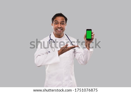 Doctor Showing Phone Smilling. Indian Man Doctor Technology Medicine at Home. Phone Green Screen Close Up Isolated