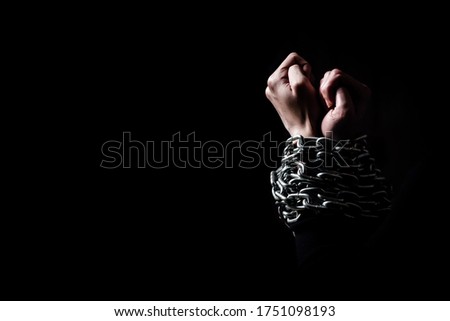 Hands in chains and in the dark