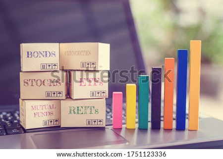 Online asset investment / portfolio diversification management for long-term profit growth concept : Boxes of financial products e.g bonds, commodities, stocks, mutual funds, ETFs, REITs on a laptop Royalty-Free Stock Photo #1751123336