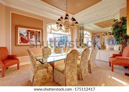 Rich dining room with wonderful dining table set, antique chairs and decorative tree