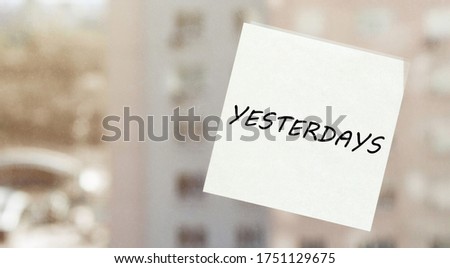 white paper with text "YESTERDAYS" on the window