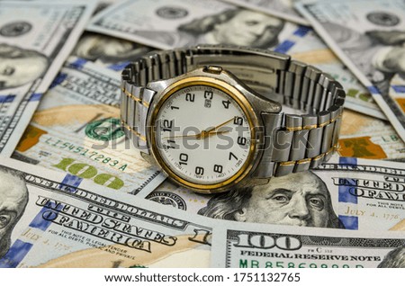 men's wristwatch on a background of dollars.