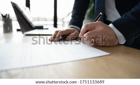 Crop close up of businessman sign paper contract make legal agreement in office, male leader or boss put signature on paperwork document close business deal at workplace, employment, law concept