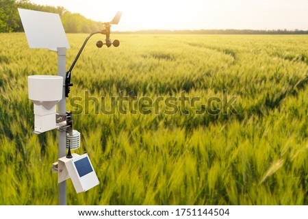 Weather station in a wheat field. Precision farming equipment Royalty-Free Stock Photo #1751144504