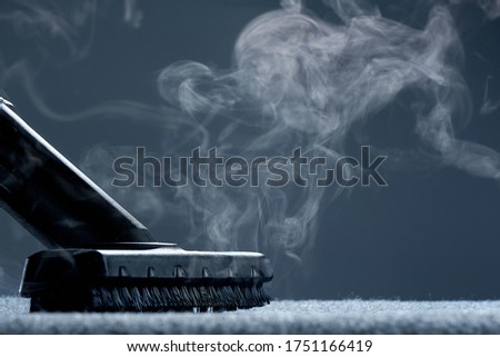 Steam carpet cleaning on a grey background. Photo with copy space. Royalty-Free Stock Photo #1751166419