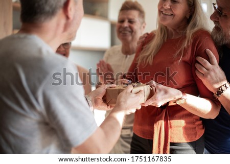 happy woman accepting congratulations from her old friends.