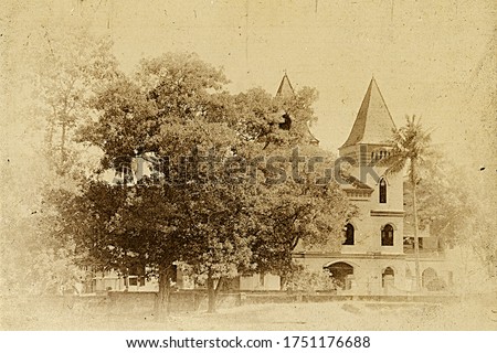 Vintage style retro photograph of an Indian building with dirt, grunge and noise in a surrounding of trees and plants.