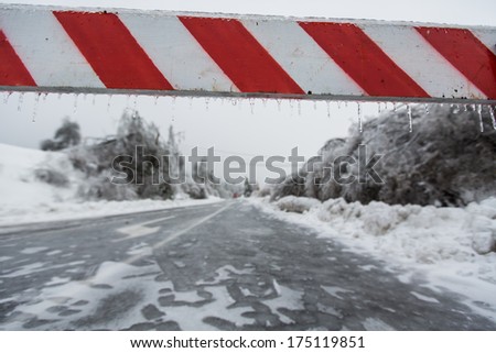 Road closed for ice with fallen trees in background