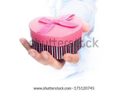 man holding pink heart shape gift box in hands on white background