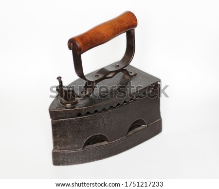 antique cast iron heavy iron with wooden handle Royalty-Free Stock Photo #1751217233