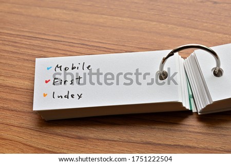 The words "Mobile First Index" written in a word book. Close-up. Royalty-Free Stock Photo #1751222504