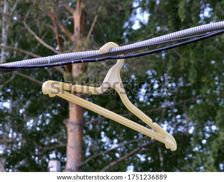 
hanger hanging on the street against the background of nature soft focus