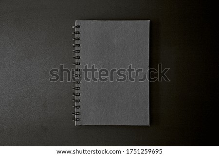 A studio photo of a blank note book