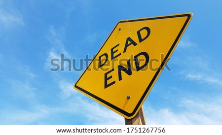 Dead End sign in closeup with clear blue sky background