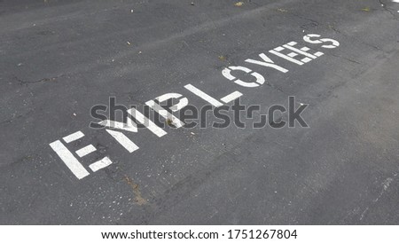 Signage of "Employee" on the pavement