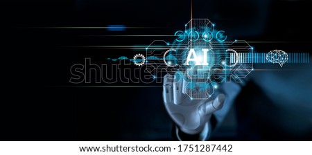 
Hand of robot touching modern interface and AI word (Artificial intelligence), Connection technology and new era of innovation, Machine learning, AI, Technology and science.