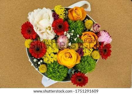 Flower bouquet of different colorful on the natural wood background. Spring style. Romantic wedding background. Floral design.